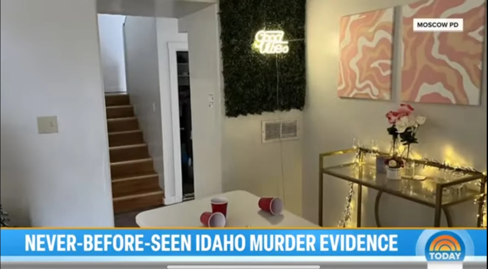 News screenshot of a room with stairs, a green wall panel and illuminated Good Vibes sign, abstract art, string lights and red cups.