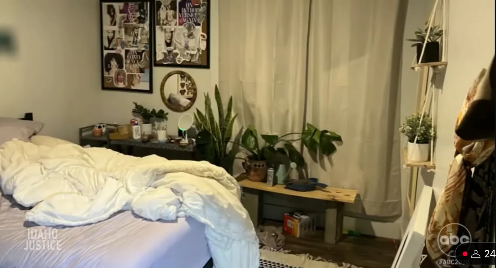 News screenshot of a bedroom with rumpled white bedding, numerous potted plants, curtains and framed photo collages.