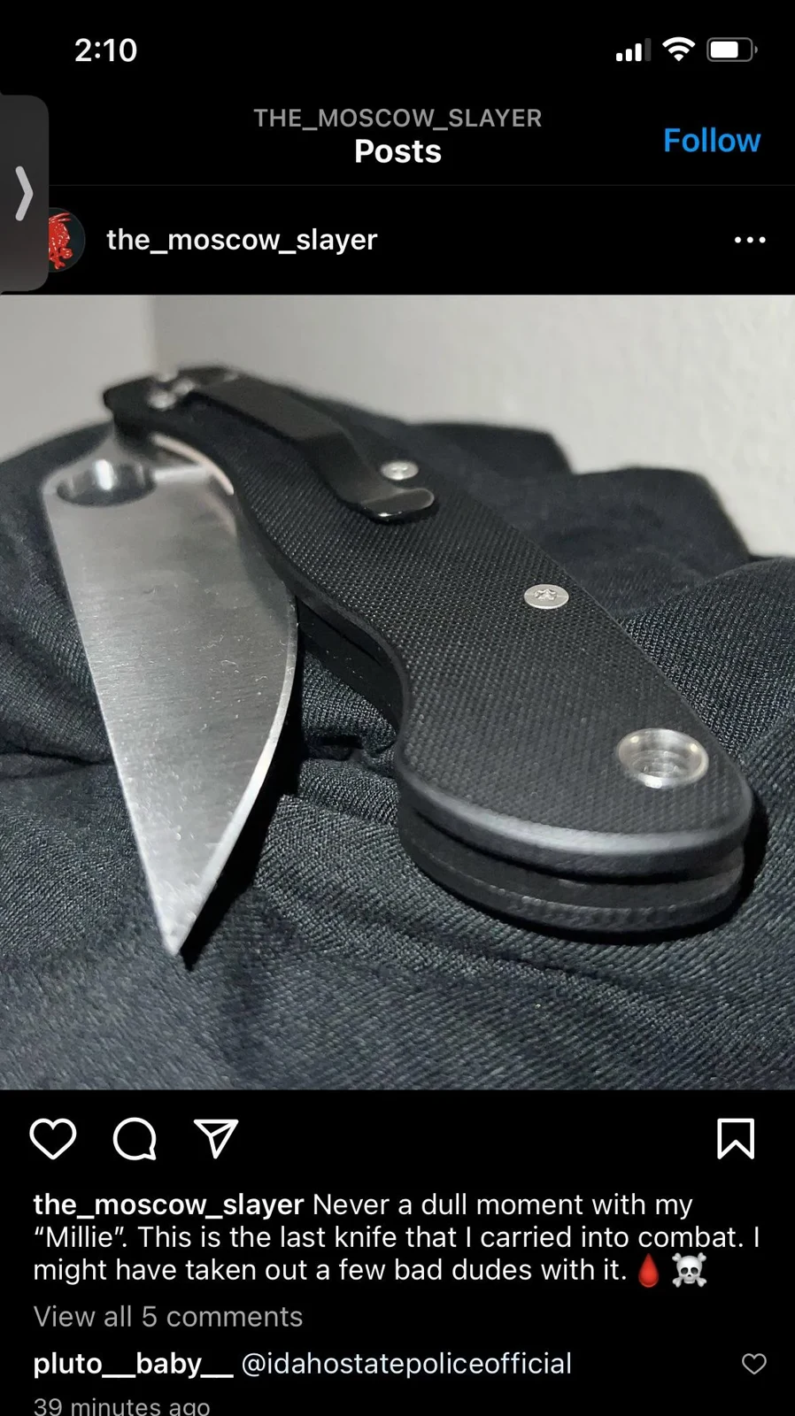 Social-media post showing an open folding knife with a black textured handle resting on dark fabric.