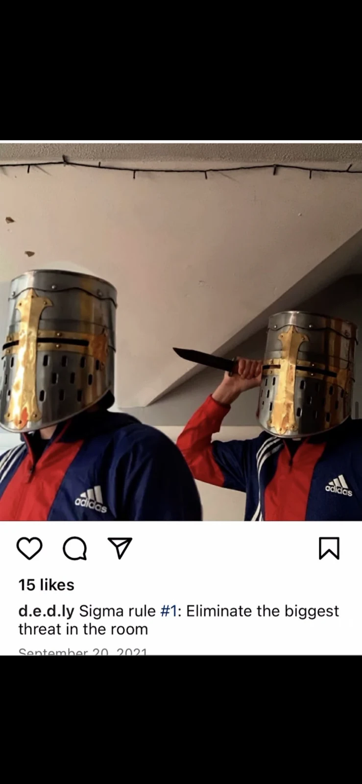 Social-media post showing two people wearing metal helmet-like head coverings and holding a dark blade-like prop.