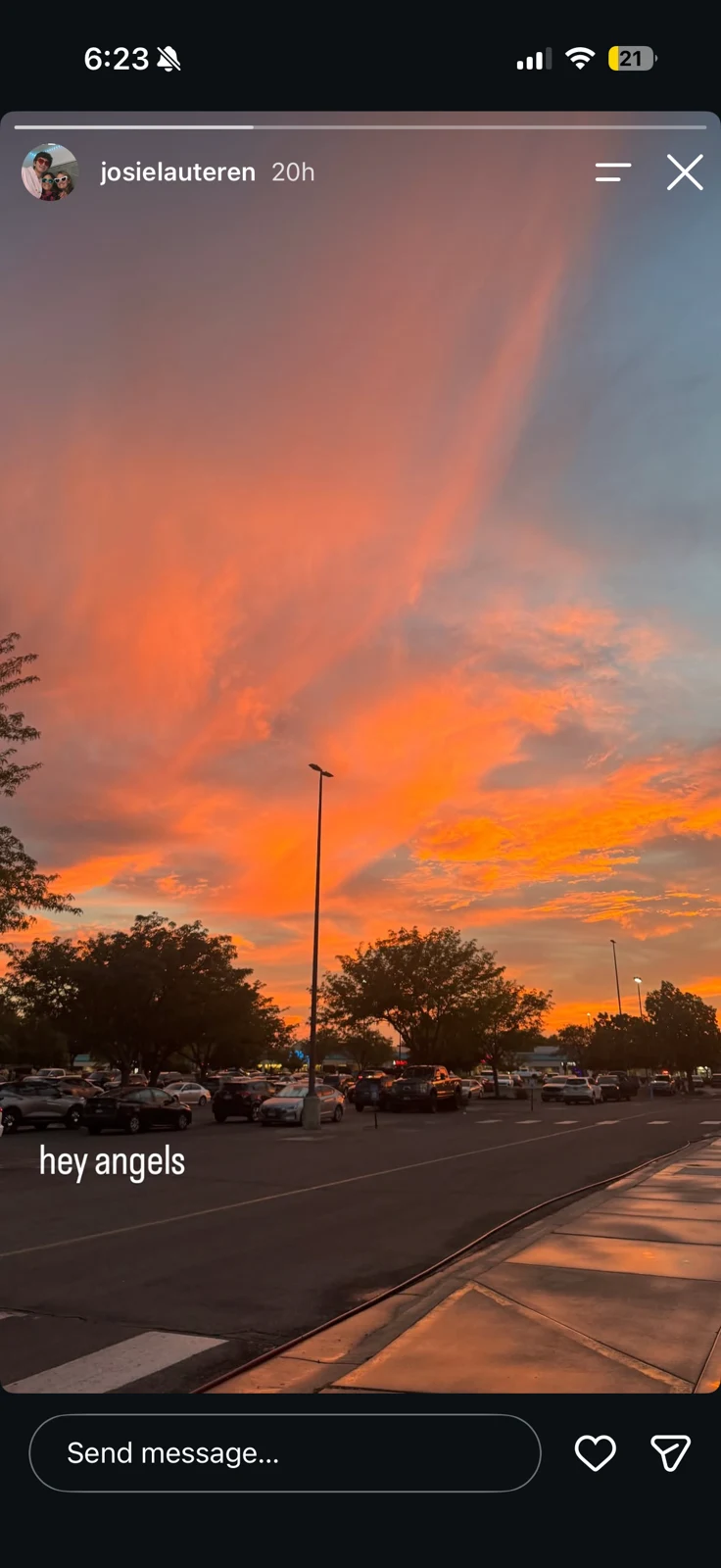 Social-media story showing a vivid orange sunset above a street and parked cars, with a short remembrance caption.