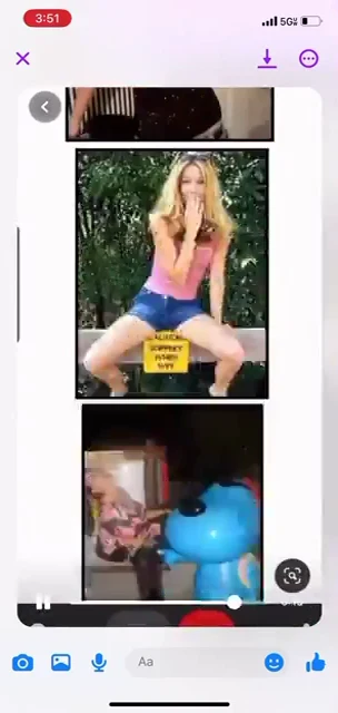Phone video screenshot of a board with posed photographs, including a person on a bench and a large blue character statue.