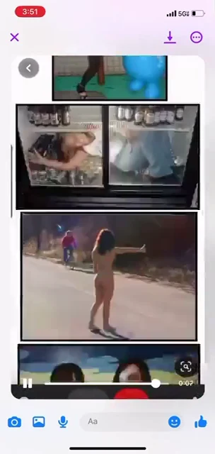 Phone video screenshot of a scrolling image board with a person standing in a road and other photographic panels.