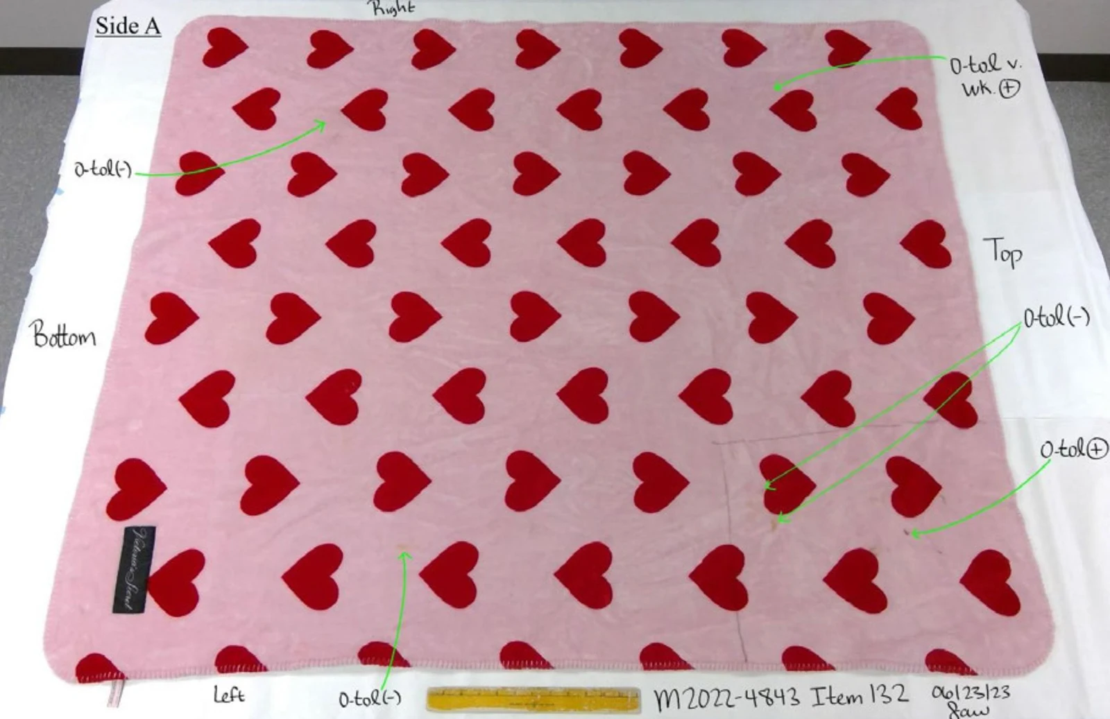 Pink rectangular mat covered in red hearts beside a yellow ruler, with arrows and handwritten testing annotations.