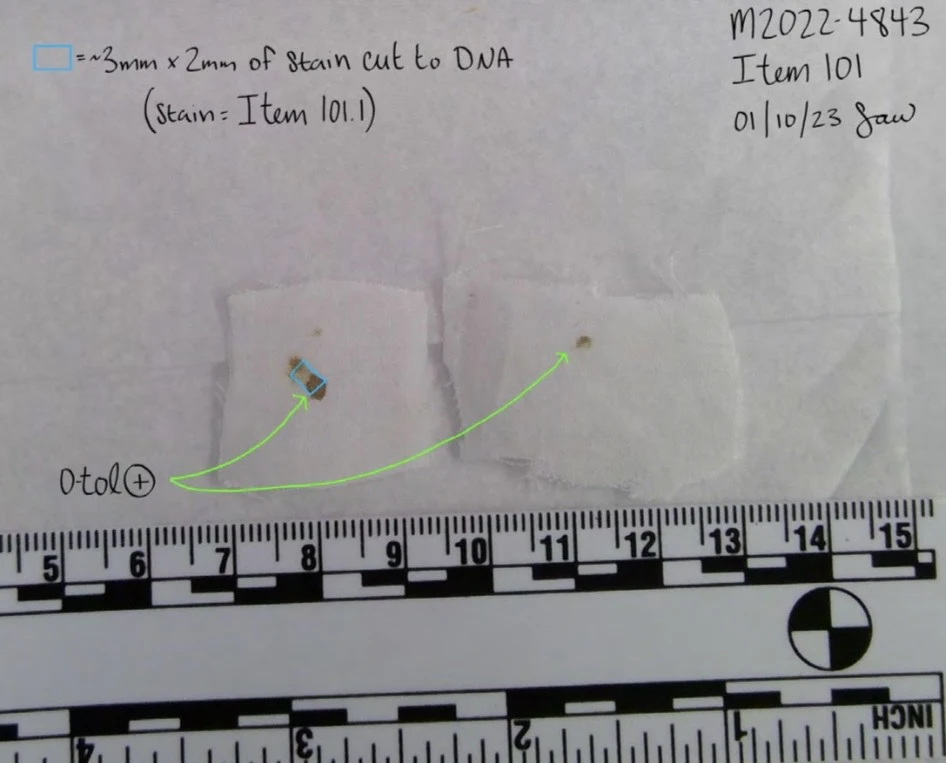 Two small white material squares with small discolored spots, photographed above a measurement scale with arrows and a sample-cut annotation.