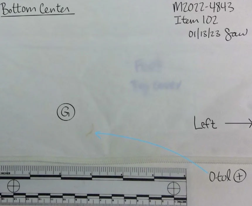 White fabric seam labeled bottom center with a circled G, blue arrow and measurement scale.