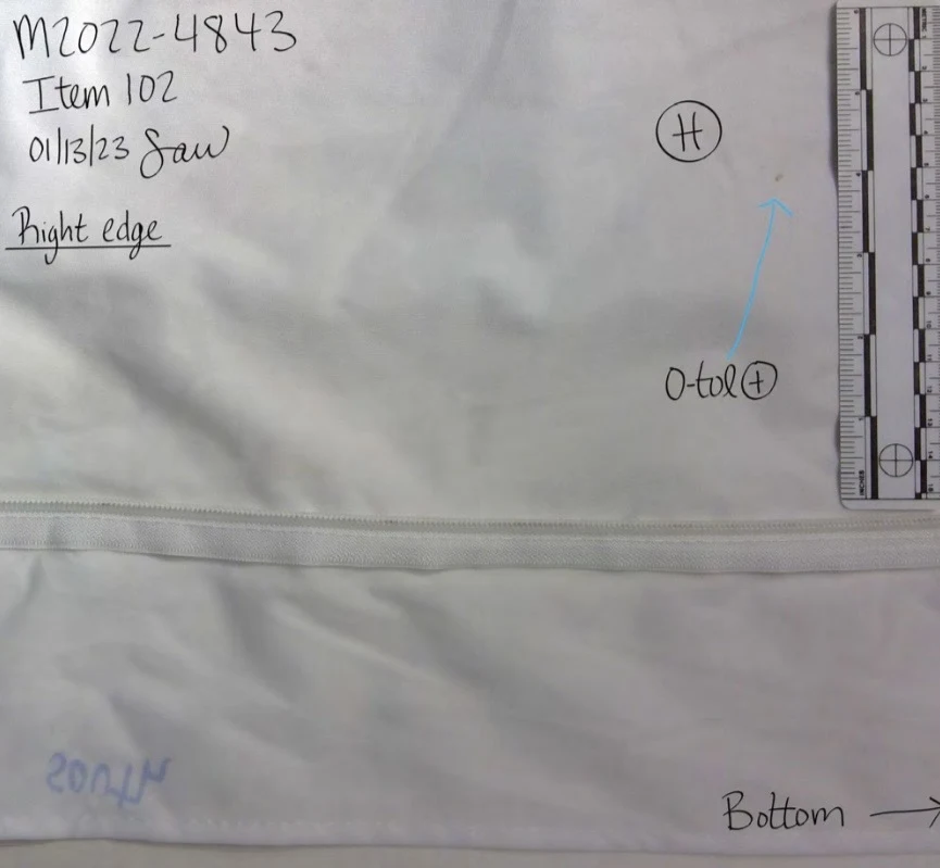White fabric near a seam labeled right edge and bottom, with a circled H, blue arrow and measurement scale.