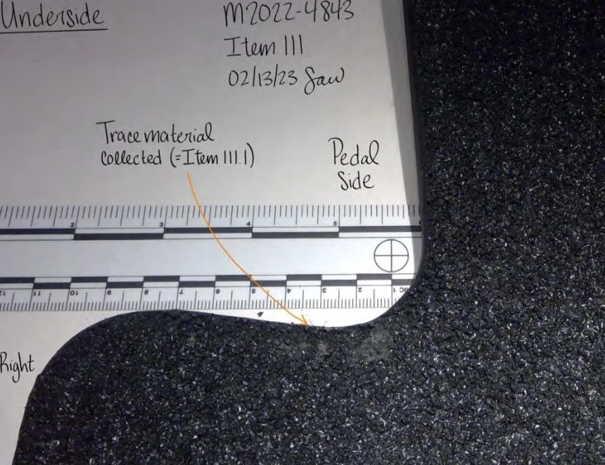 Close view of a notched floor-mat edge from underneath, beside a measurement scale and trace-material collection annotation.