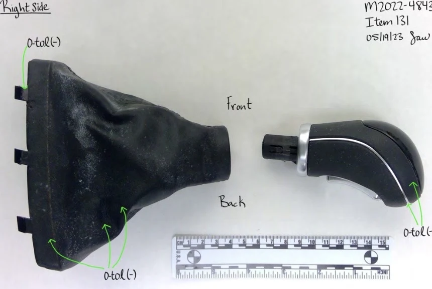 Right-side view of a detached gear-shift knob and black boot, with green arrows and a measurement scale.