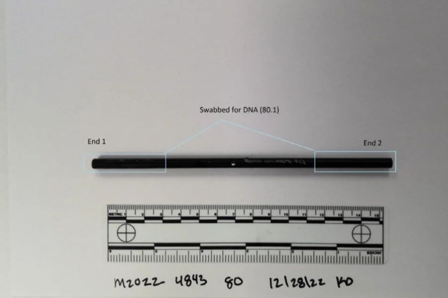 A narrow black cylindrical object above a measurement scale, with both ends outlined and labeled as swabbed areas.
