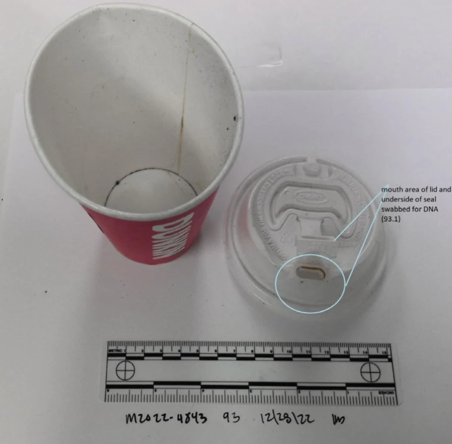 Used red paper drink cup beside a clear lid, with swab-area circles around the lid openings and a measurement scale below.