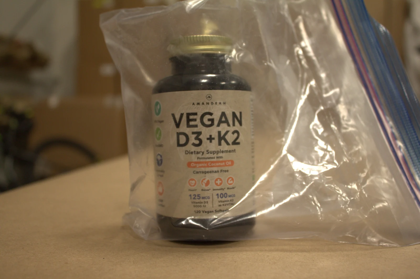 Bottle labeled Vegan D3+K2 dietary supplement inside a clear resealable plastic bag.
