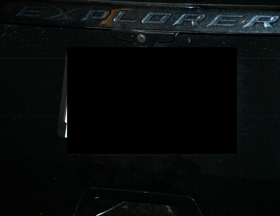 Close view of the Explorer rear badge and a redacted license plate area.