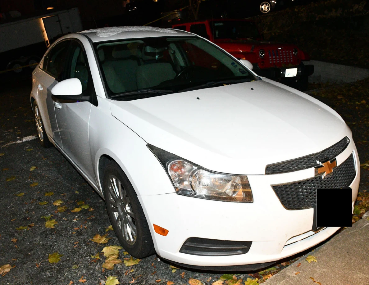 Front and side of a white Chevrolet sedan.