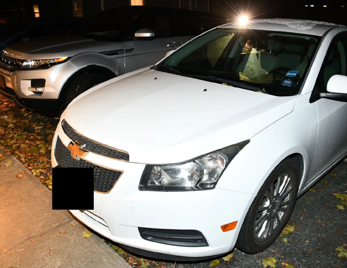 White Chevrolet sedan with a silver SUV behind it.
