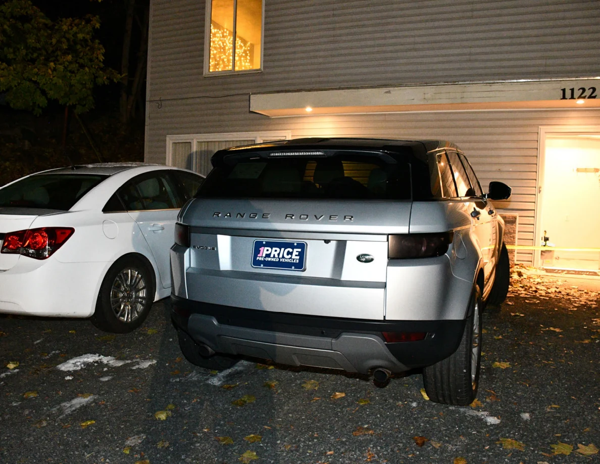 Rear of a silver Range Rover outside a house.