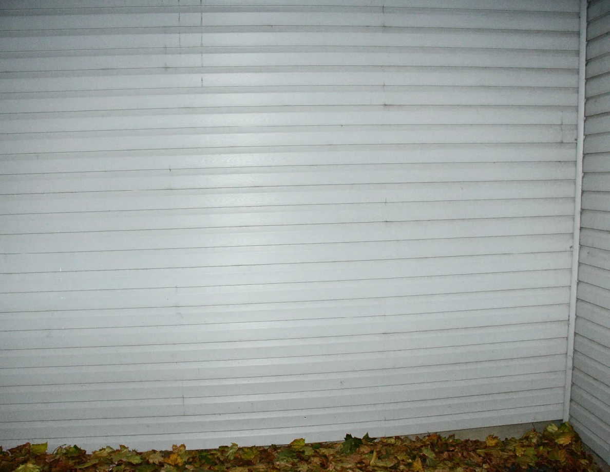 Exterior siding with vertical streaks near the lower wall.