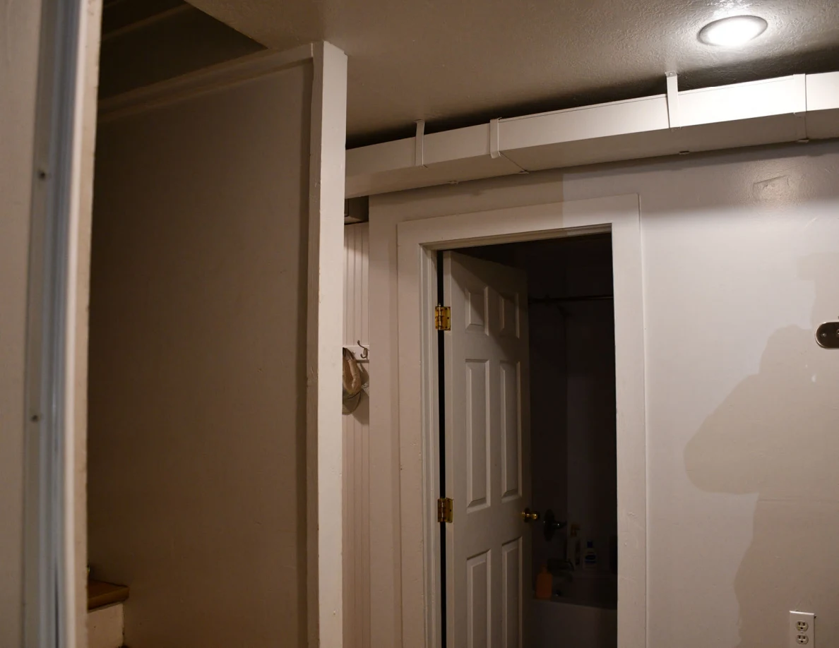 Interior doorways beneath exposed ceiling ductwork.