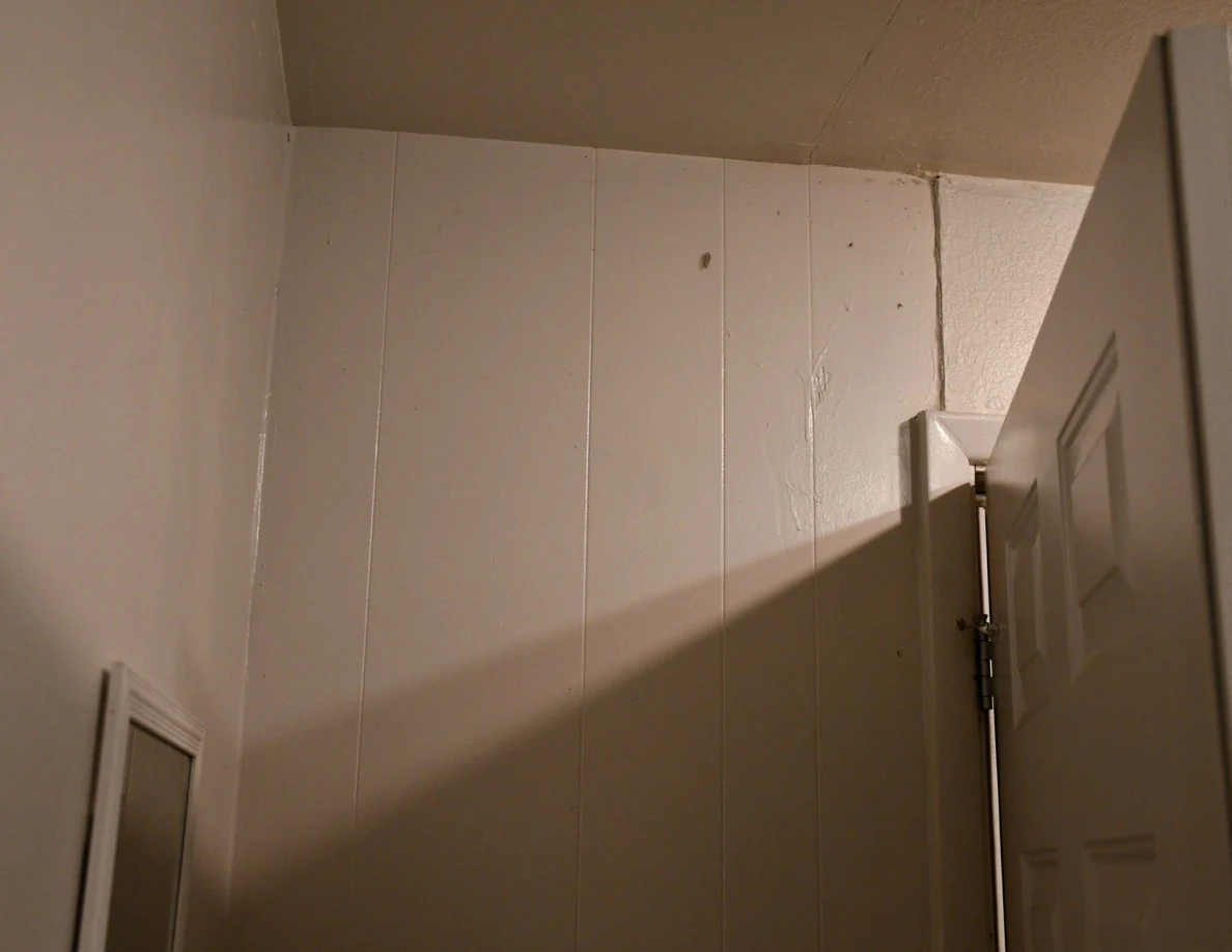 Upper wall panels and top edge of an open door.