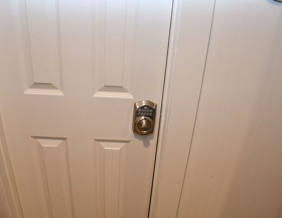 Close view of a closed door and keypad knob lock.