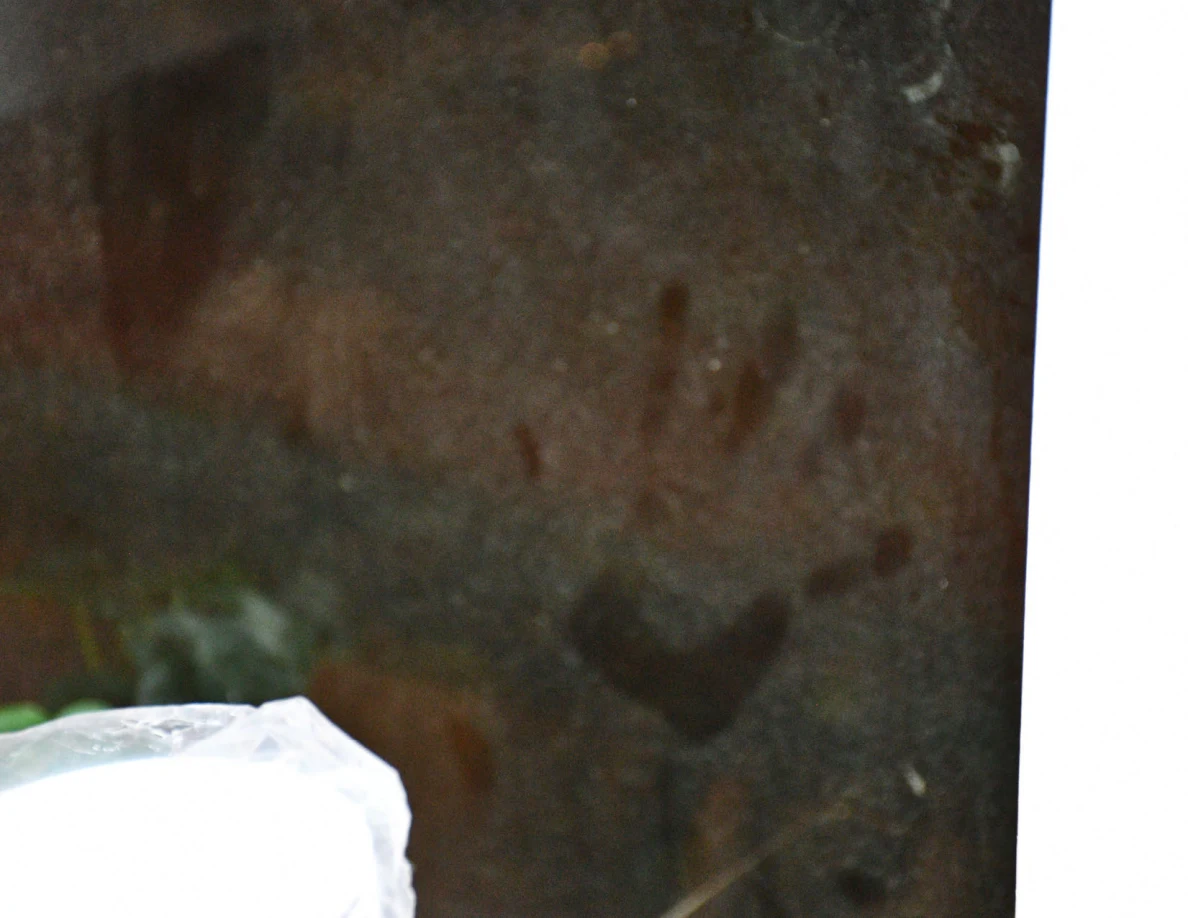 Close view of smudges on glass; their origin is not established visually.