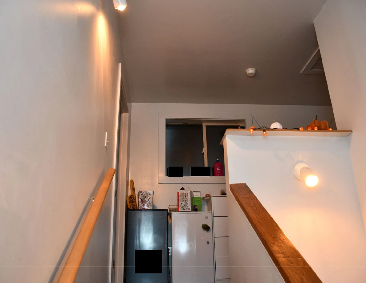 Upper landing with compact refrigerators, drawers and window.