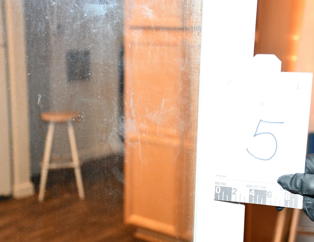 Reference card 5 held beside sliding-door glass with kitchen beyond.