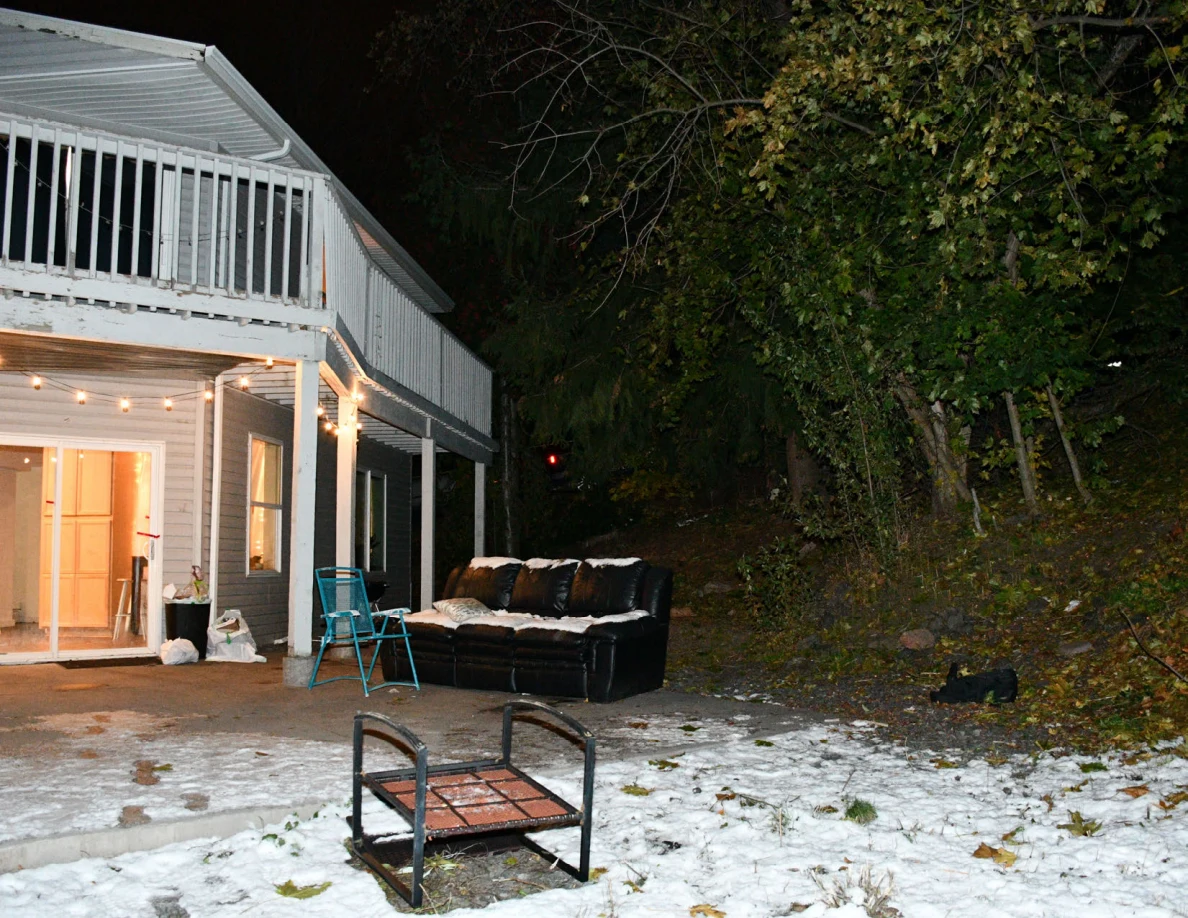Rear balcony, patio sofa and outdoor chair on snowy ground.