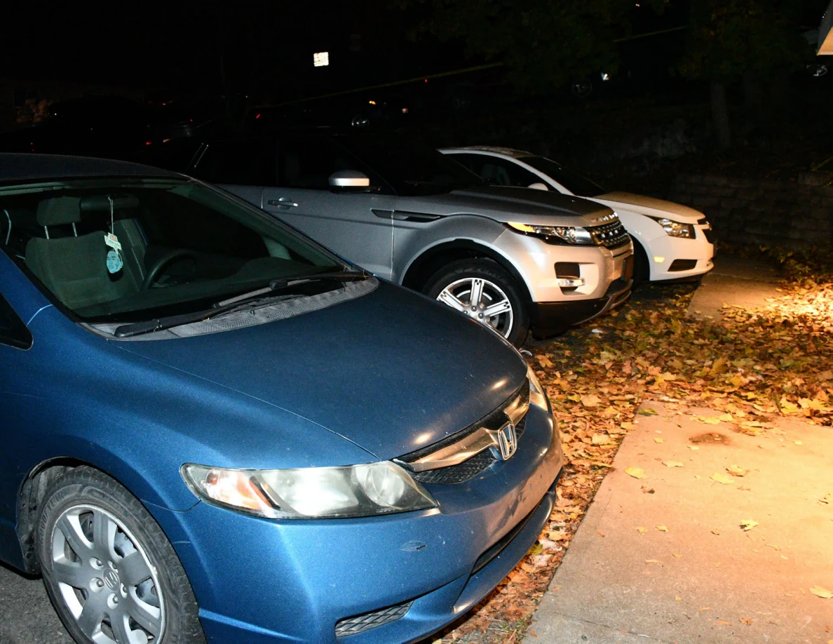 Blue sedan, silver SUV and white car parked in a row.