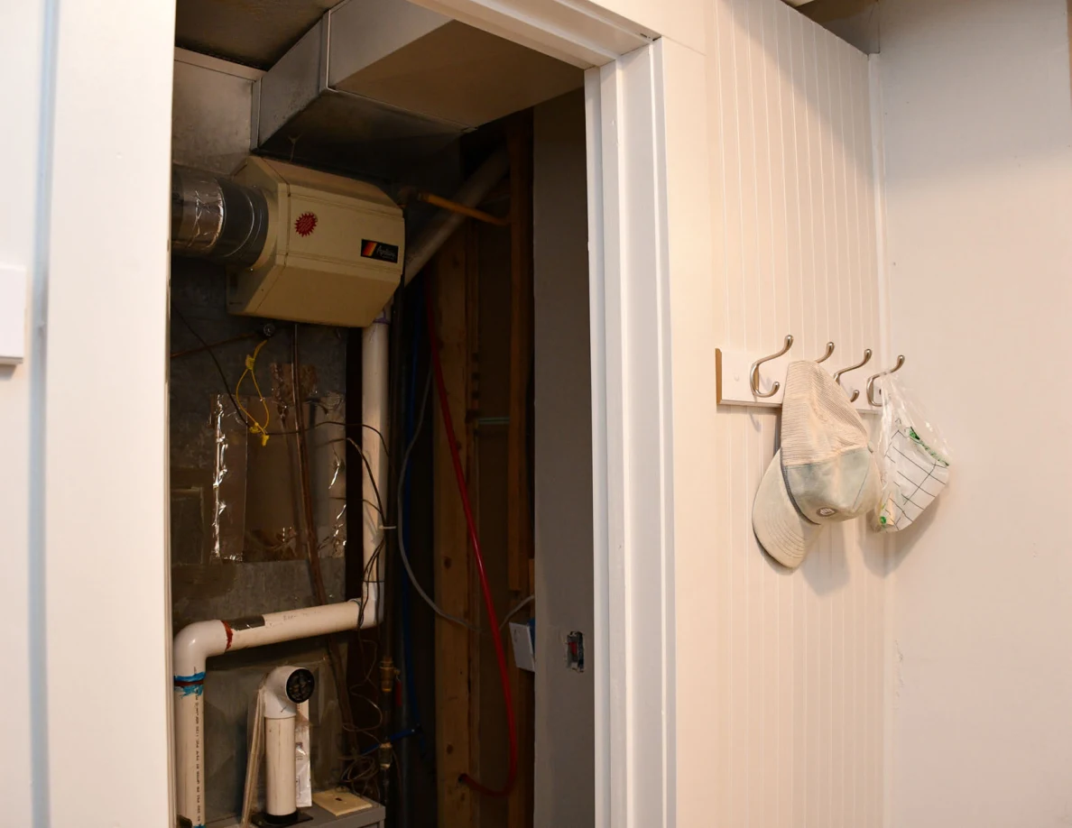 Upper utility closet with ducts, wiring and pipes.