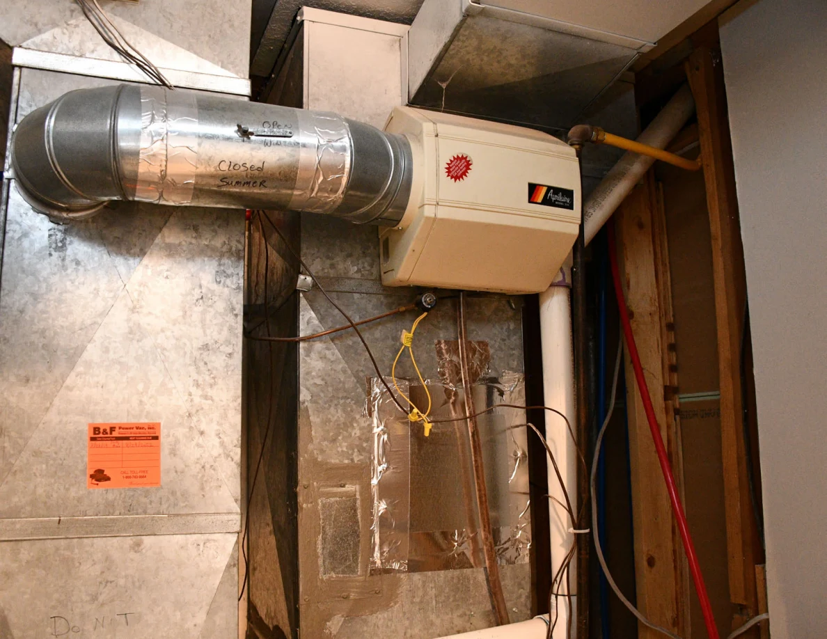 Close view of metal ductwork and mounted utility equipment.