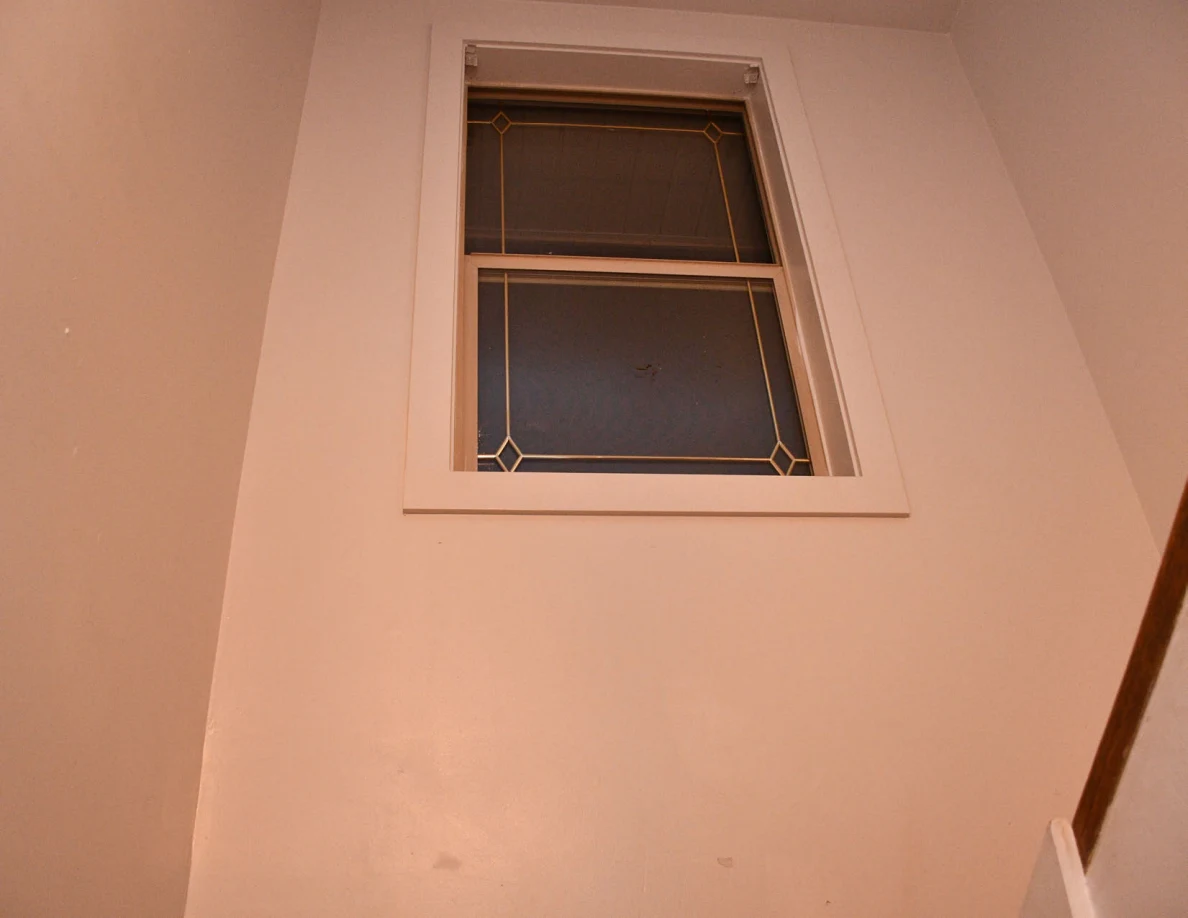 Stairwell window and surrounding walls.