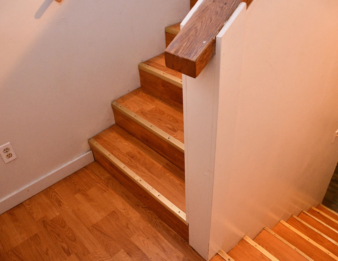 Wooden stair landing, steps and railing.