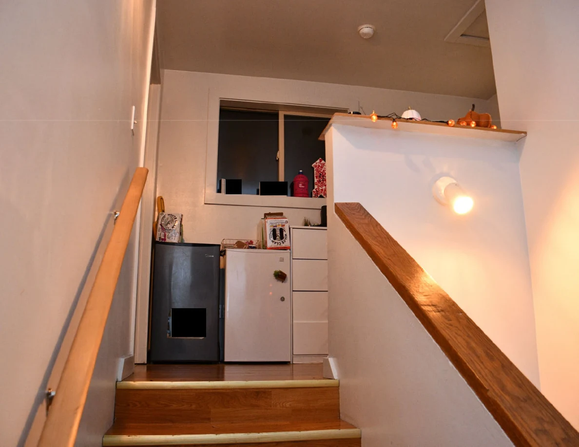 Steps leading to landing with compact refrigerators and drawers.