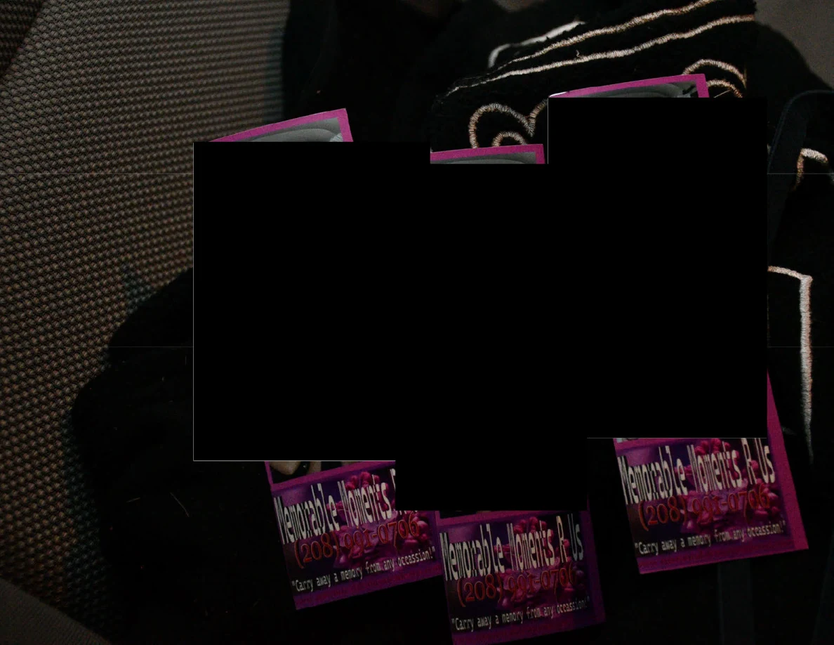 Close view of partially redacted printed items on vehicle upholstery.