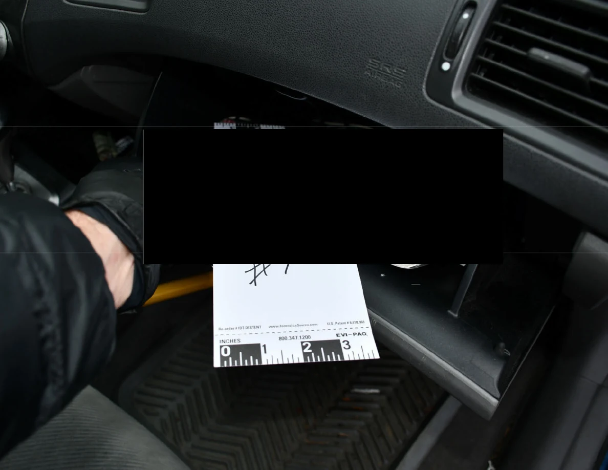 Open glove compartment and reference card with a large redaction over its contents.