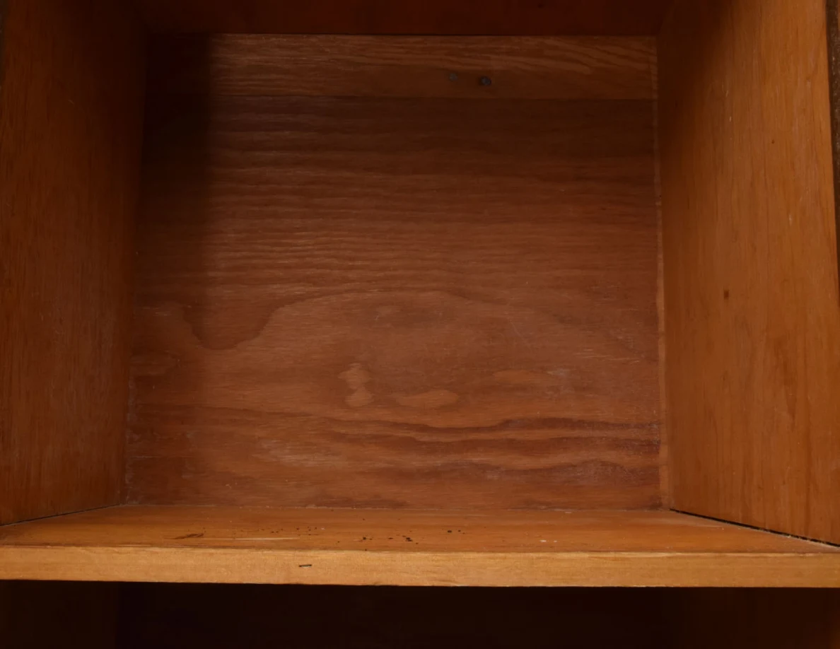 Empty wooden cupboard shelf with visible wood grain.