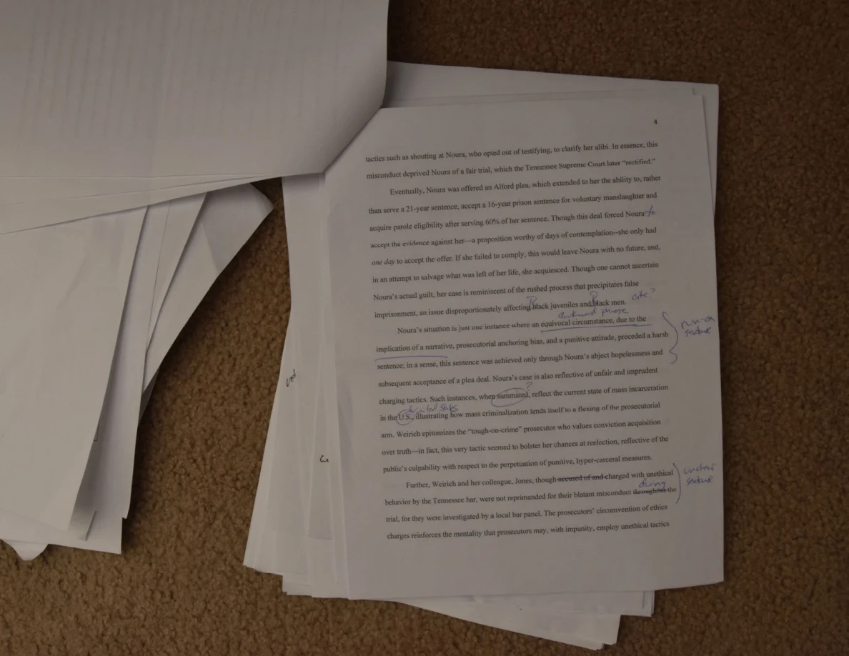 Printed essay page with handwritten corrections and notes along the right margin.