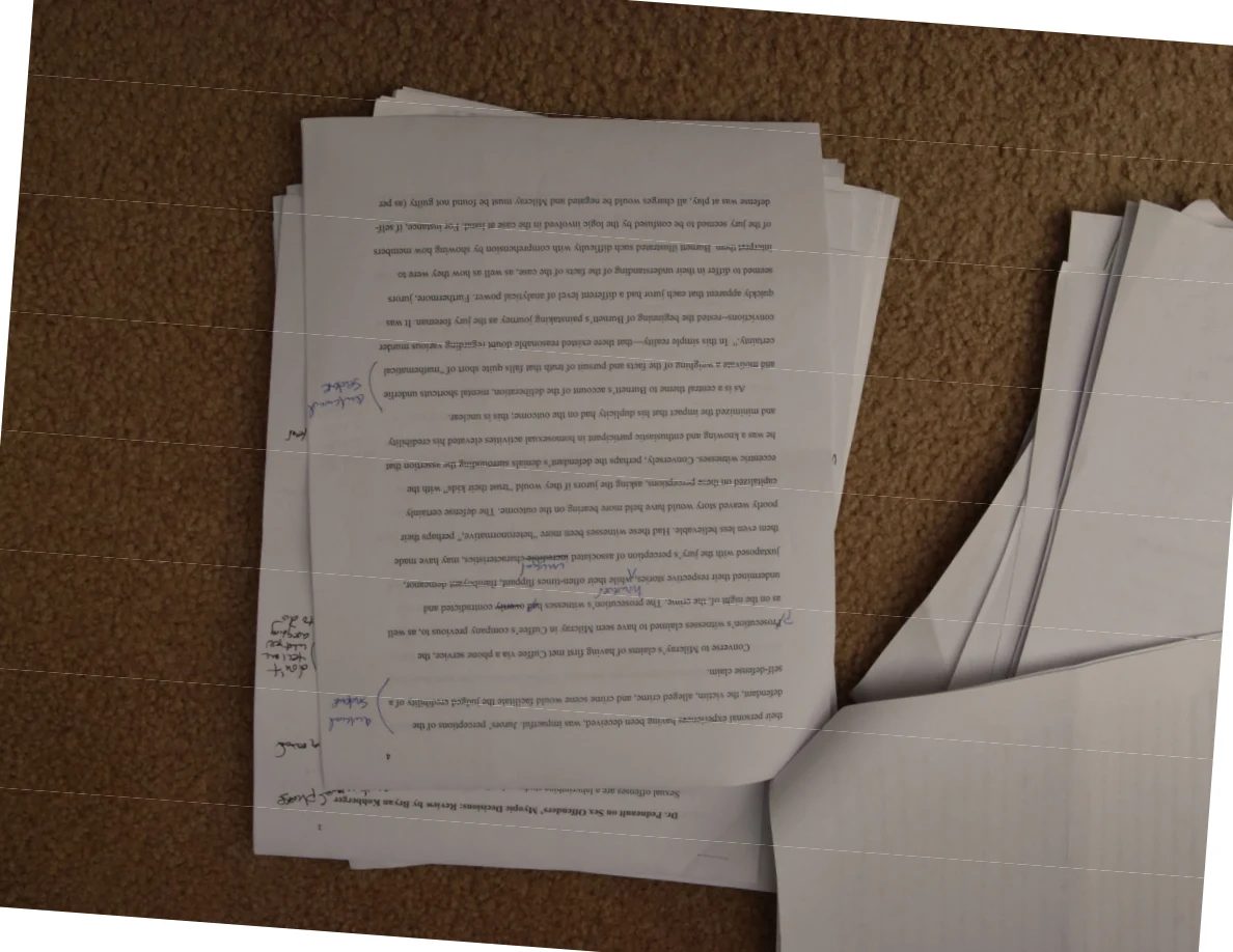 Upside-down printed page with handwritten notes along the left margin and faint horizontal image lines.