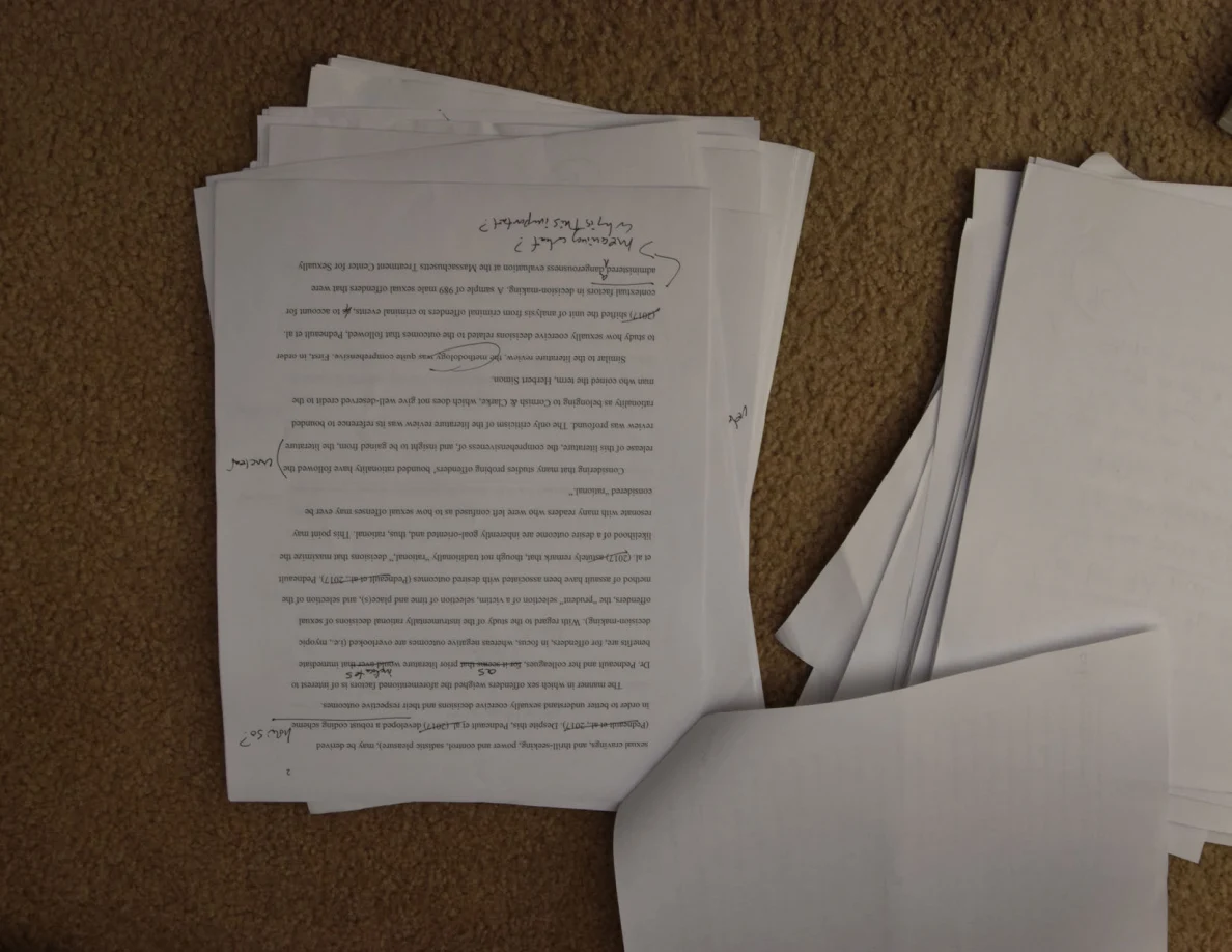 Upside-down printed page with handwritten corrections and a circled passage.