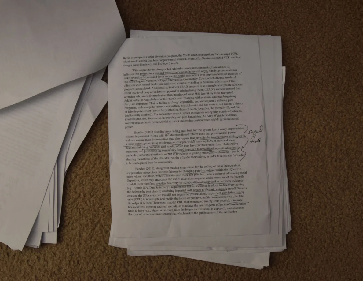 Dense printed essay page with a bracket and handwritten comment in the right margin.