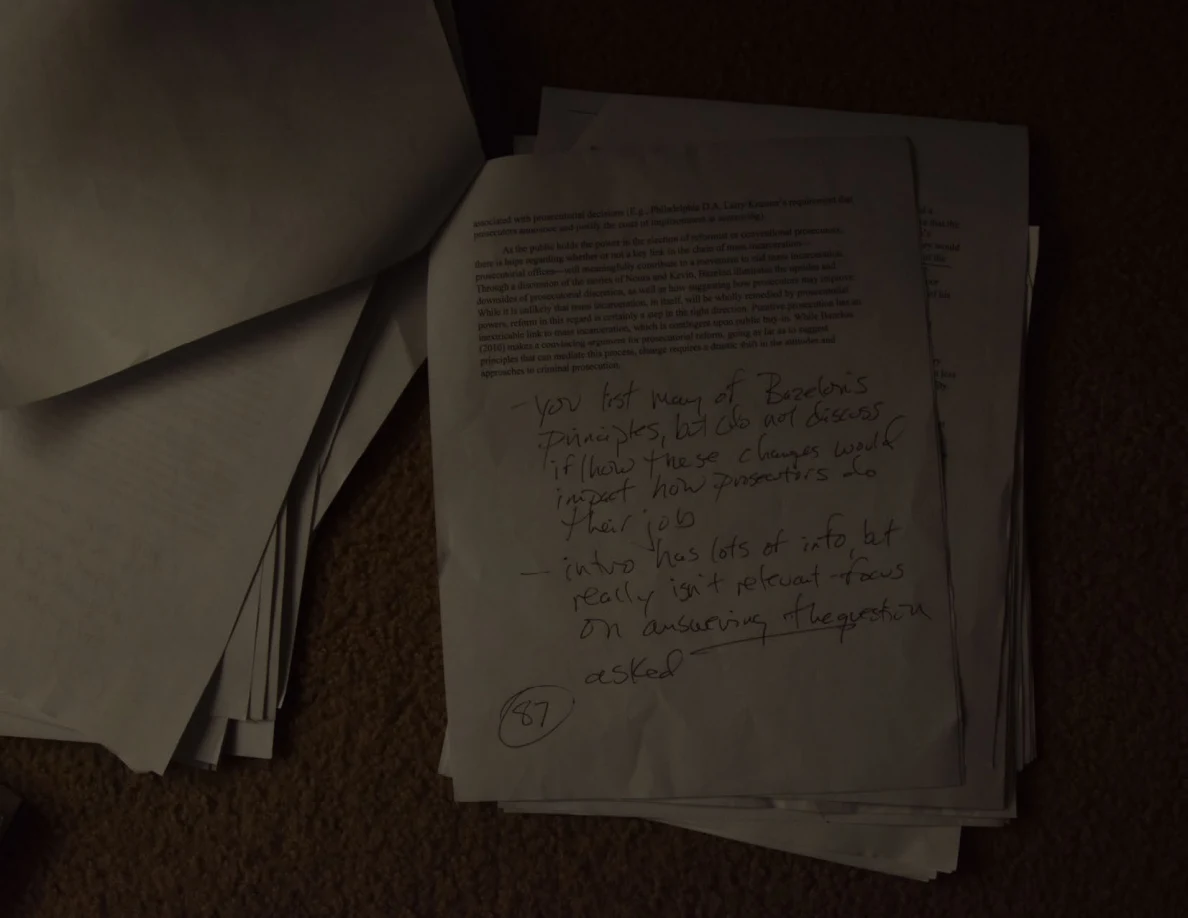 Dim printed page with large handwritten feedback filling its lower half.