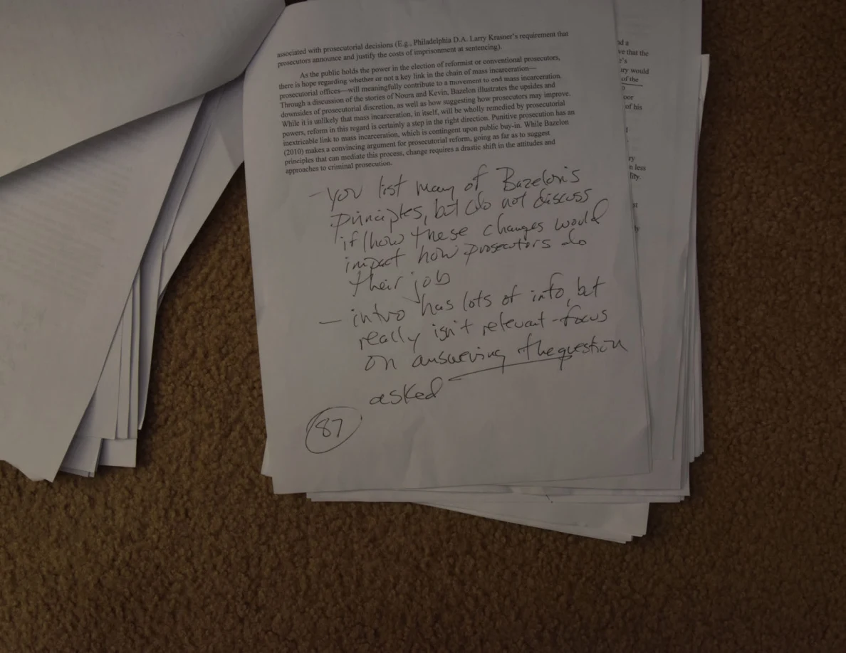 Closer view of a printed page with large handwritten feedback and a circled number beneath it.