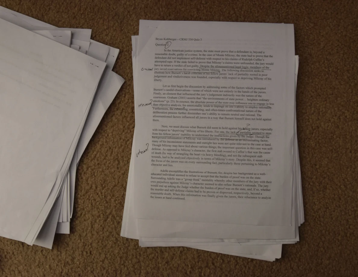 Printed essay page with handwritten annotations in the left margin.