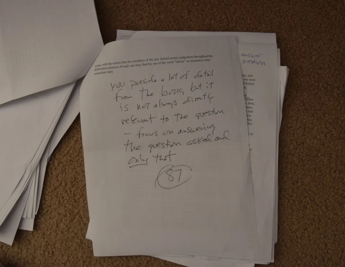 Printed page with large handwritten feedback and a circled number in the lower half.