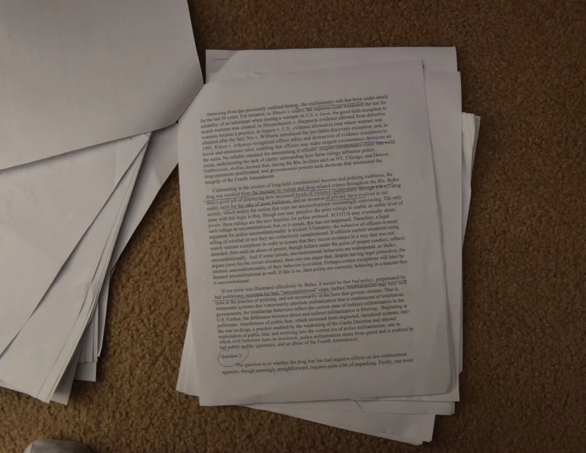 Printed essay page with handwritten marks and a circled passage near the bottom.