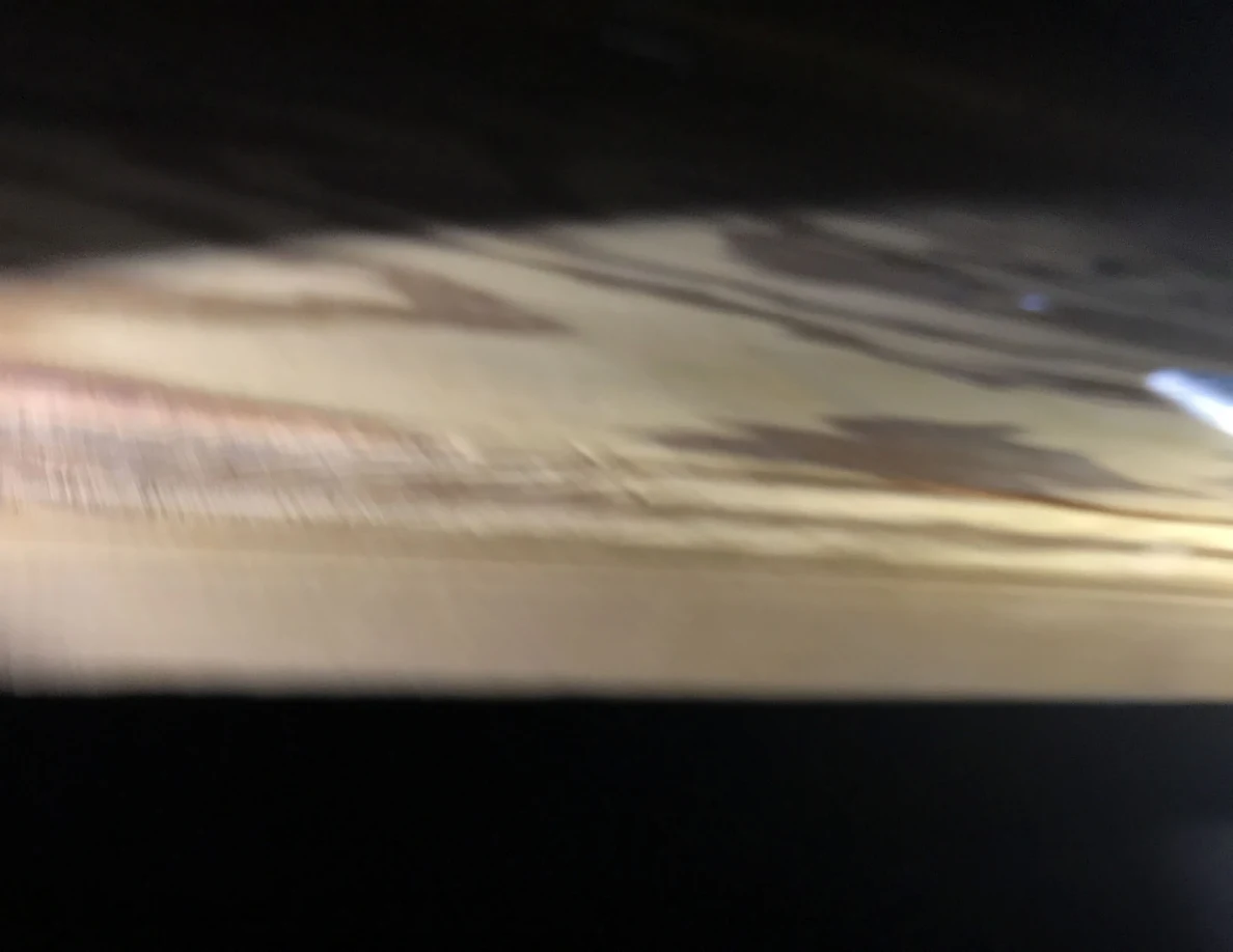 Blurred close view along a plywood panel edge.