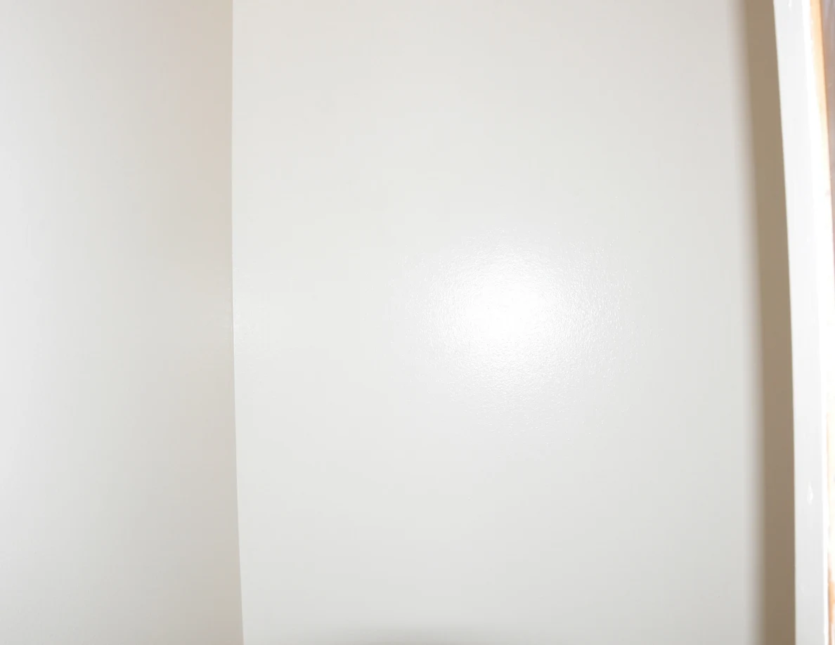 Close view of a plain pale interior wall and corner.