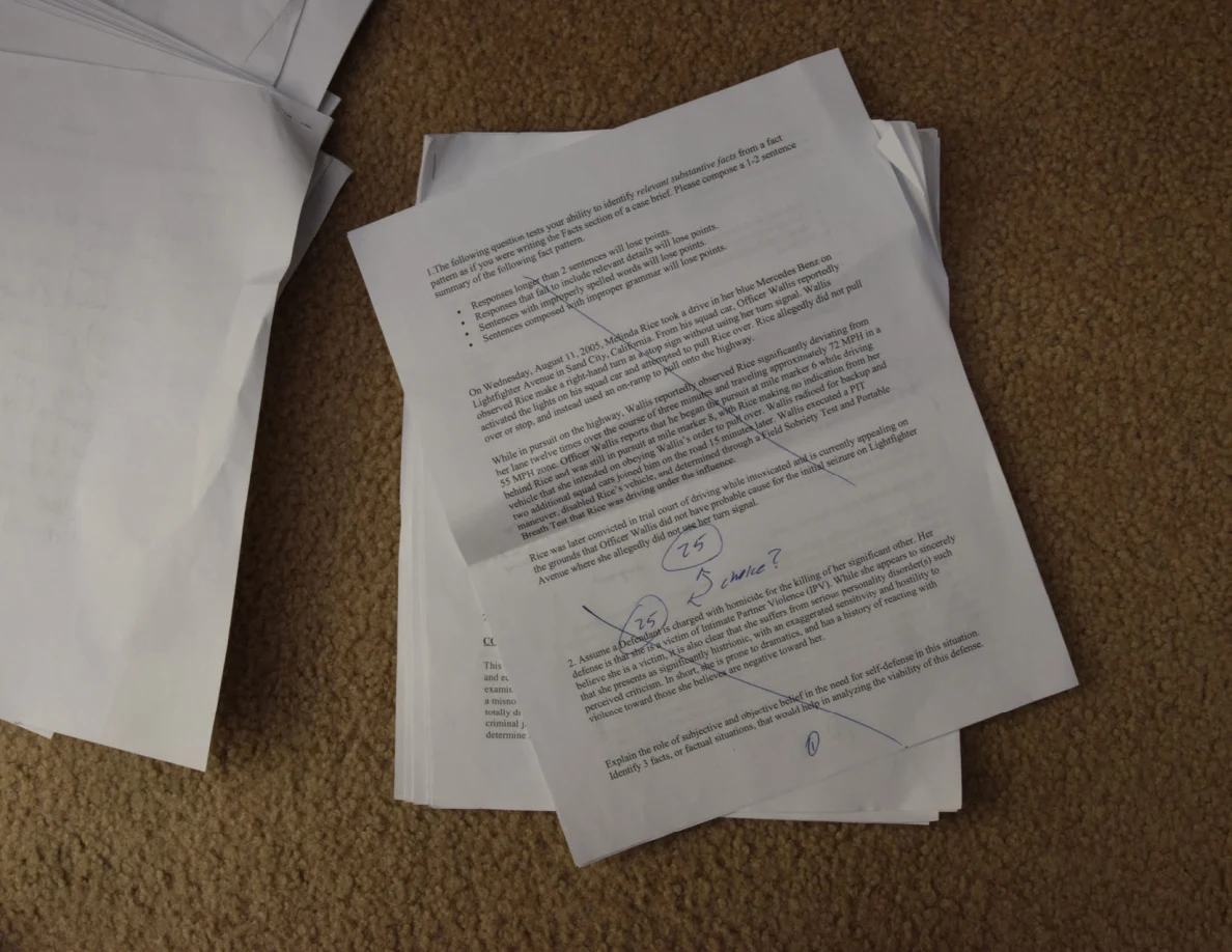 Printed assignment sheet with numbered questions, handwritten notes and circled marks.