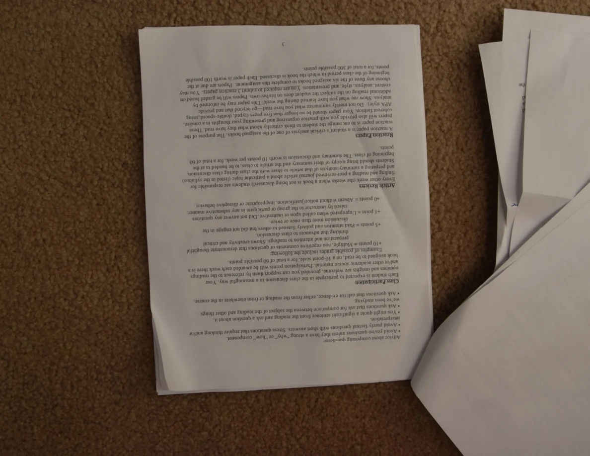 Upside-down printed page of course instructions and paragraphs.